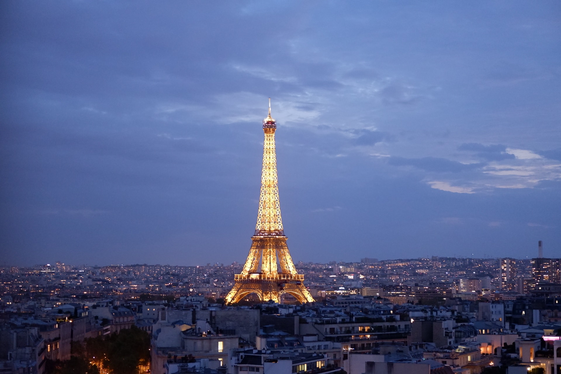 The mighty Eiffel Tower gleaming bright in the night sky in Paris, a thing of beauty to behold. 