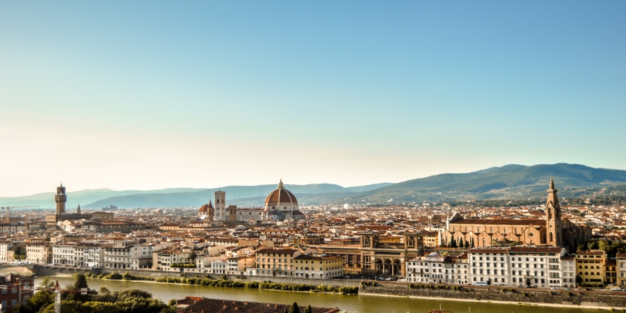 From a captivating top view, Florence reveals its timeless allure with a mosaic of terracotta roofs, embraced by the city's rich history and enchanting Tuscan charm