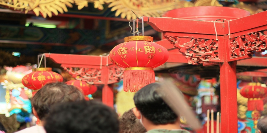 Immerse in the vibrant Thailand Lunar New Year market with bustling stalls, colorful decorations, and lively festivities.