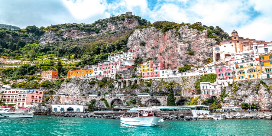 Breathtaking coastal view of Amalfi Coast's colorful villages nestled among cliffs - a top European destination for summer