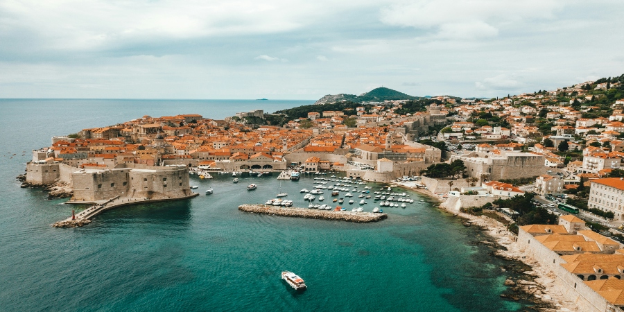 Dubrovnik's Old Town with its medieval walls and terracotta rooftops - explore the Adriatic gem in summer.