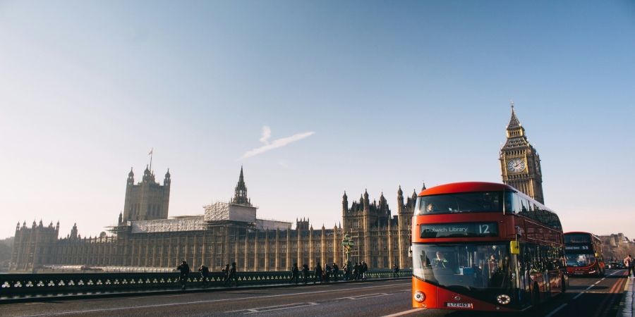 London bus against iconic Big Ben backdrop: Captivating image showcasing the city's charm and historic landmarks in one breathtaking frame.